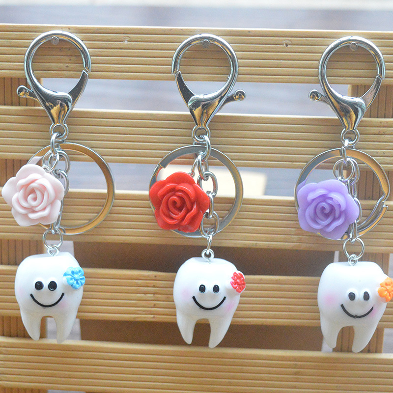 Smiling teeth shape key chain with flower